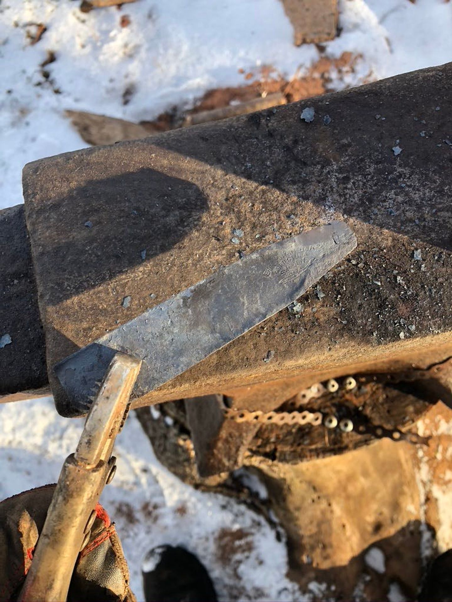 Holding the initial metal over the anvil